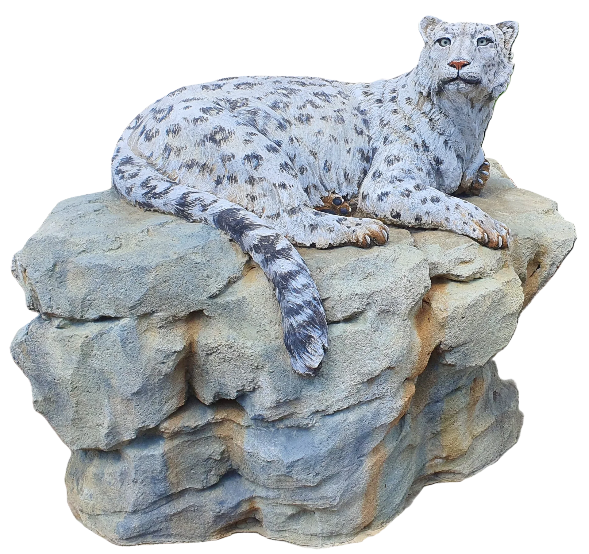 Concrete snow leopard reclining on a broad artificial rock formation.